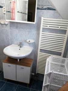 a bathroom with a sink and a mirror at schönes Ferienhaus mit grossen Pool 250 m vom Balaton in Balatonmáriafürdő