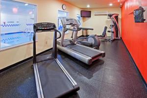 a gym with cardio equipment and a swimming pool at Wingate by Wyndham Youngstown - Austintown in Youngstown