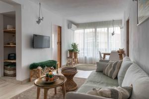 a living room with a couch and a table at Brand new Javea apartment 50m from Arenal beach in Jávea