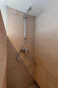 a shower with a shower head in a bathroom at Brand new Javea apartment 50m from Arenal beach in Jávea