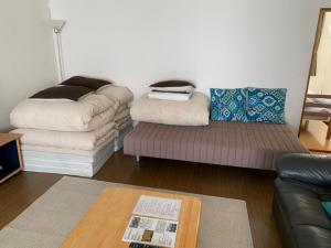 a living room with a couch and a chair at STAY3‐11 in Asahikawa