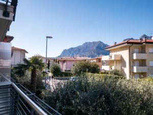 a city with buildings and a mountain in the background at Appartamento Benji1 in Nago-Torbole
