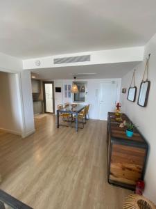 a living room with a table and a dining room at Apartamento Adrover in Cala Millor