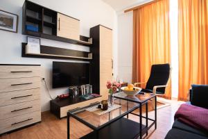 a living room with a television and a coffee table at Apartment Mari in Dubrovnik