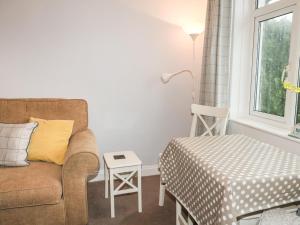 a living room with a couch and a table at Fairview in Salcombe