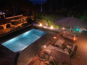 an overhead view of a swimming pool at night at Casa Tanio 150m walking from the village and town of Tamariu in Tamariu
