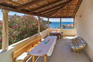 balcón con mesa, sillas y vistas al océano en Apartment Astelas, en Dubrovnik