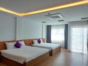 Giường trong phòng chung tại TH Quy Nhơn Hotel