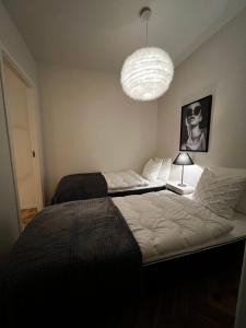 una camera con un grande letto e un lampadario a braccio di Nice apartment very close to Isaberg Hestra a Nissafors