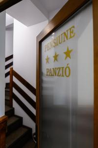 a sign for the entrance to the entrance to penna pennao at Juliu's Panzio Csikszereda in Miercurea-Ciuc