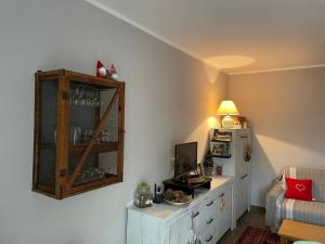 a living room with a cabinet and a television at Casa con vista in Corniolo +30 photos