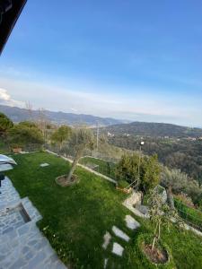a garden with a view of the mountains at Sunrise Holiday Home in Camogli