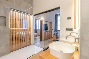 a bathroom with a white tub and a sink at Villa Giade in Chiavenna