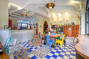 a restaurant with a table and chairs on a checkered floor at Moon Star Villa in Xiaoliuqiu