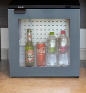 een kleine koelkast gevuld met flessen en blikjes frisdrank bij Hotel Mignon Riccione Fronte Mare in Riccione