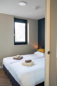 מיטה או מיטות בחדר ב-Strand, Zee & Meer