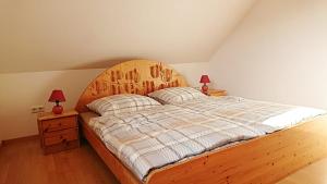 a bedroom with a large wooden bed with two lamps at Ferienwohnung Edermündung in Haldorf