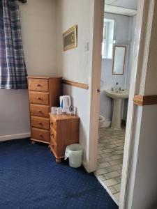 a bathroom with a sink and a toilet and a dresser at Canasta Hotel in Blackpool +25 photos