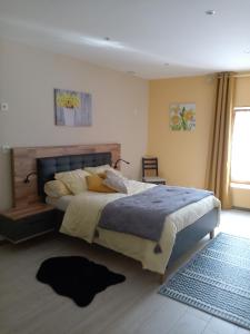 a bedroom with a large bed and a rug at Jonquille Chic La Piccola Venezia in Vrécourt