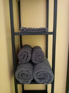 a shelf with three rolls of towels on it at Jonquille Chic La Piccola Venezia in Vrécourt