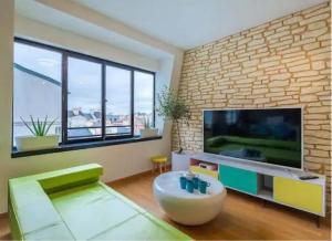 a living room with a large flat screen tv at VERY CENTRAL DISNEYLAND apartment in Serris
