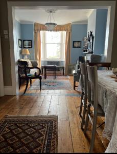 a dining room with a table and chairs and a living room at Gloucester House in Hastings