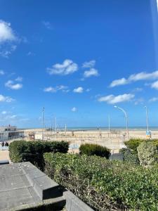 a view of a beach with people walking on it at Les Embruns in Trouville-sur-Mer
