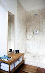 a bathroom with a shower with a wooden table at Residence Alouettes in Hyères