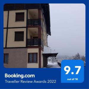 a picture of a building with the words travel review awards at Apartman Jelen in Kaludjerske Bare