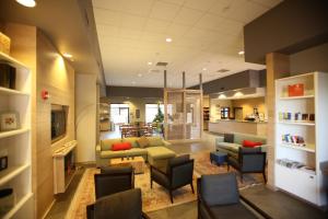 a lobby with a couch and chairs and a table at GreenTree Inn & Suites Phoenix Sky Harbor in Phoenix