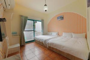 Postel nebo postele na pokoji v ubytování Rainbow B&B