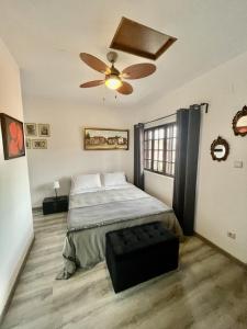 a bedroom with a bed and a ceiling fan at Casa do Beco B&B Douro - Guest House in Parambos +165 photos