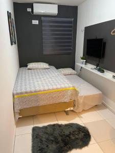 a bedroom with a bed and a dog laying on the floor at Flat JK 102 in Juazeiro do Norte