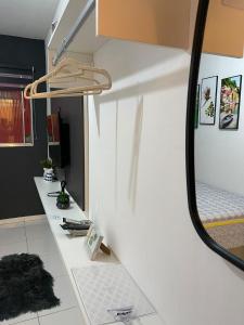 a bathroom with a mirror and a white counter at Flat JK 102 in Juazeiro do Norte