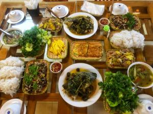 a table full of plates of food with rice at Tam Coc Nature in Ninh Binh