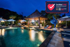 a swimming pool at night with a gazebo at Sunset Garden Nusa Lembongan in Nusa Lembongan