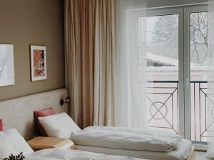 a hotel room with two beds and a window at Anna apartment in Subotica