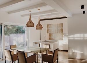 a kitchen with a dining room table and chairs at Anna apartment in Subotica