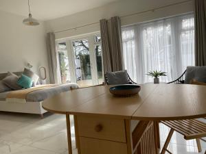 a living room with a table and a couch at Garden Room in Kirton in Lindsey