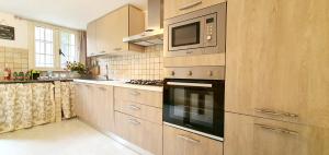 a kitchen with a microwave and a stove top oven at Pieno Centro Apartment in Tropea