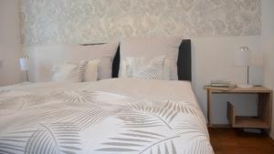 a bedroom with a white bed with two pillows at Rosenwinkel Appartement im EG in Halberstadt