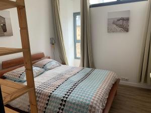 a bedroom with a bunk bed and a window at Appartement LE TRITON in Perros-Guirec