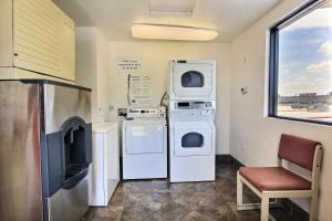 a laundry room with two washer and dryers and a window at Motel 6 Austin, TX - Central Downtown UT in Austin
