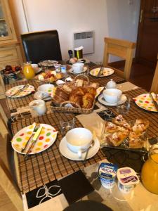 a table with food and dishes on top of it at La Grange bnb in Yviers +4 photos