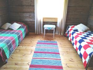 A bed or beds in a room at Yläpihan Tila