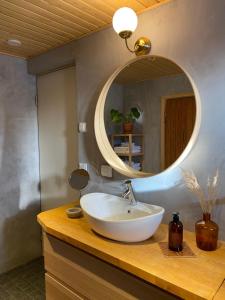 a bathroom with a white sink and a mirror at Villa Aini in Rovaniemi
