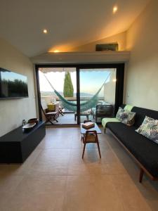 a living room with a couch and a table at Appartement vue mer à Gigaro, La Croix-Valmer in La Croix-Valmer