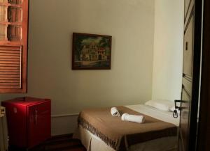 a bedroom with a bed and a picture on the wall at Pousadinha Copacabana in Rio de Janeiro