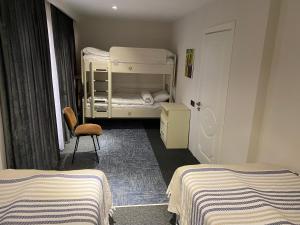 a bedroom with two bunk beds and a chair at Guest house in Qusar