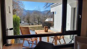a view of a table and chairs from a window at Bungalow mit Terrasse im alpinen Stil in Schliersee